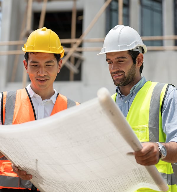 Reviewing blueprints at construction site